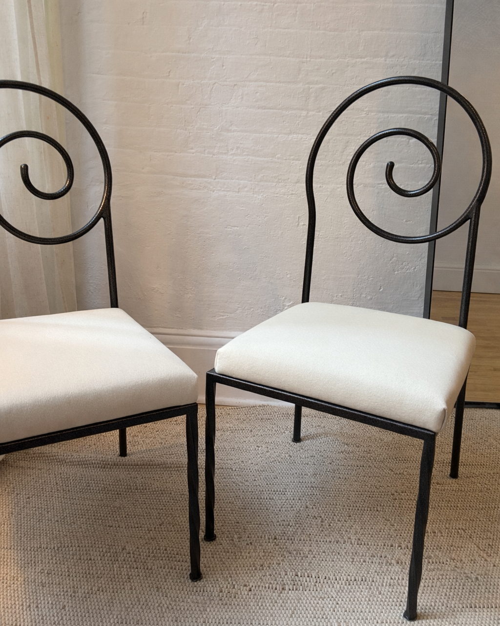 scroll-back iron chairs in cream wool