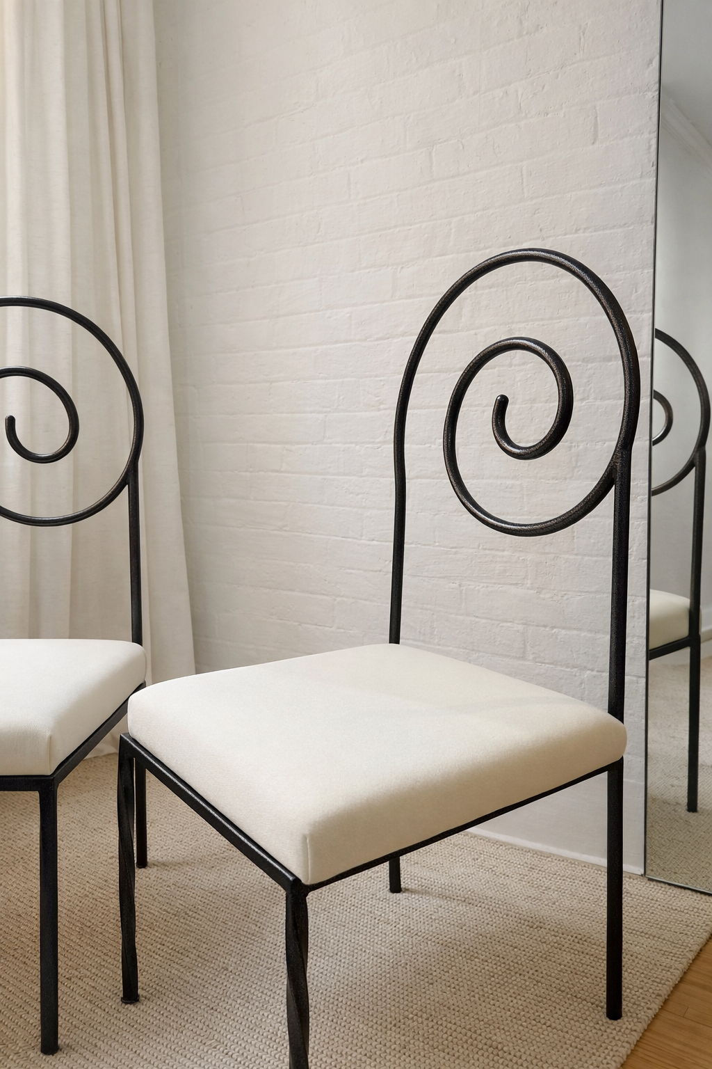 scroll-back iron chairs in cream wool