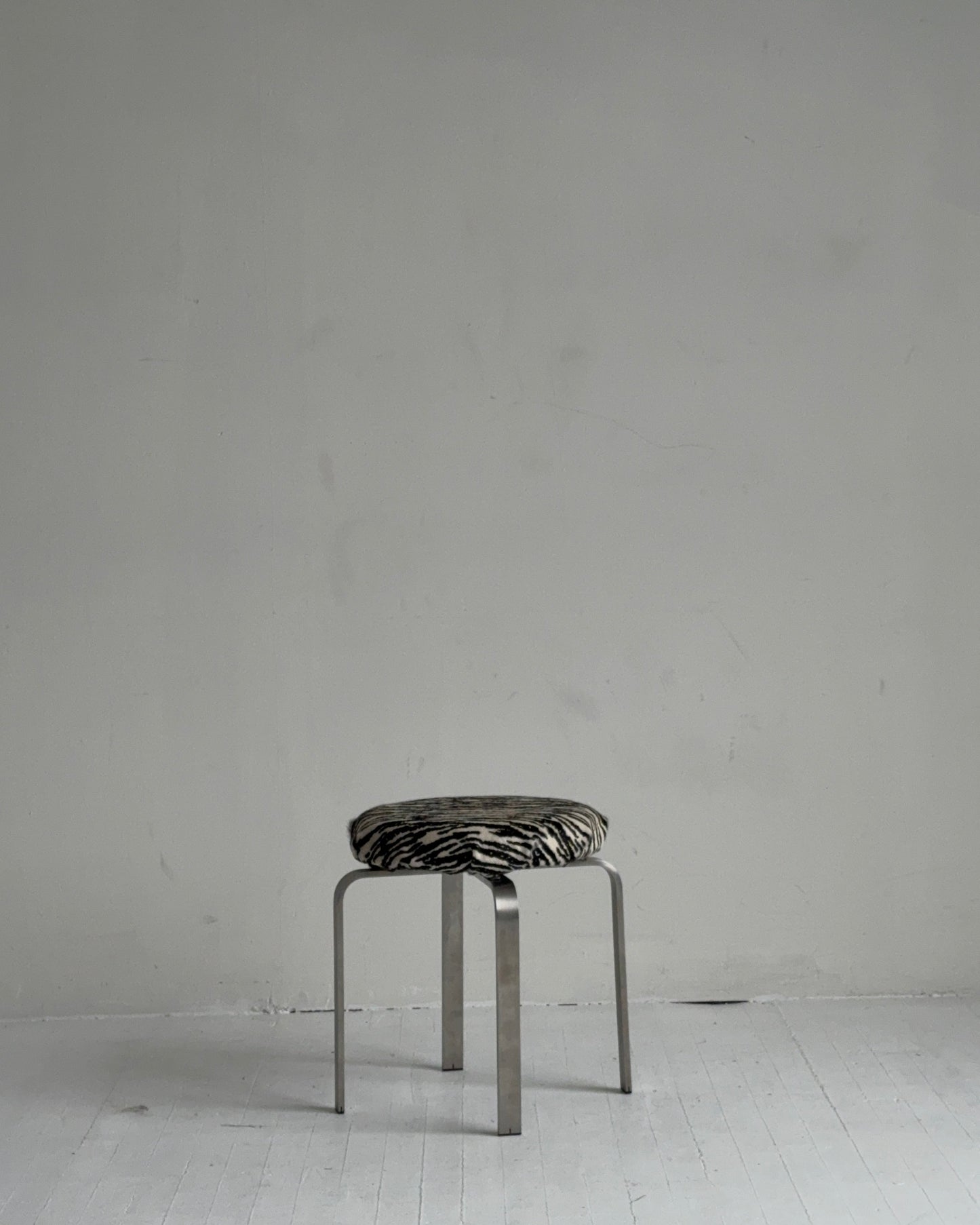 sculptural chrome pedestal stool in zebra calf hair