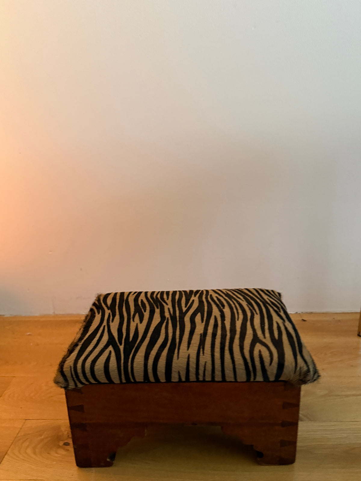 antique dovetailed footstool in custom tiger calf hair